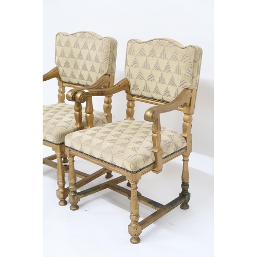 4 - A pair of early 20th century gilt framed theatre seats with beige geometric upholstery, scrolled arm... 