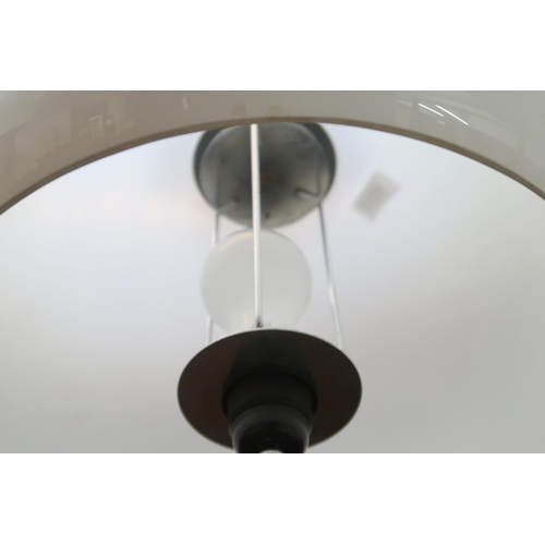 72 - A 20th century after Guzzini standard lamp with domed acrylic shade on chromed upright with circular... 