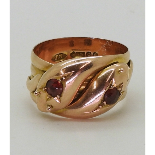 2711 - A ROSE GOLD DOUBLE SNAKE RINGthe 9ct gold serpents heads are set with garnets, bears a London hallma... 