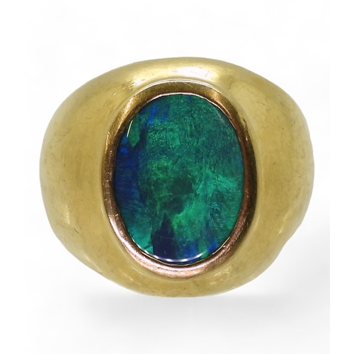 2721 - A GENTS OPAL SET RINGthe wide dome shaped ring is made of 18ct yellow gold , set with a 14mm x 10mm ... 