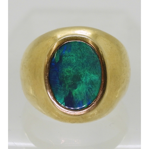 2721 - A GENTS OPAL SET RINGthe wide dome shaped ring is made of 18ct yellow gold , set with a 14mm x 10mm ... 