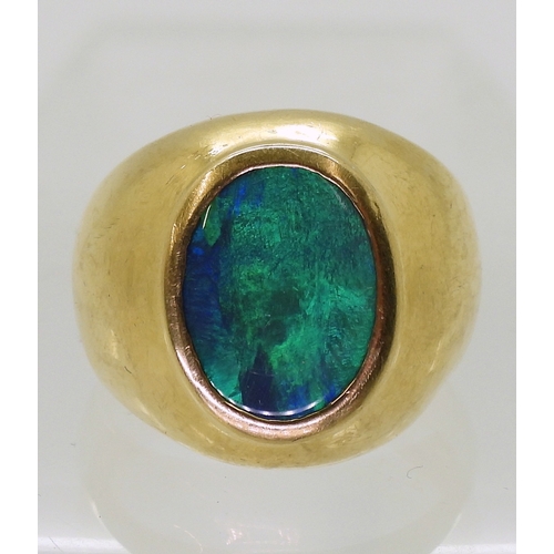 2721 - A GENTS OPAL SET RINGthe wide dome shaped ring is made of 18ct yellow gold , set with a 14mm x 10mm ... 