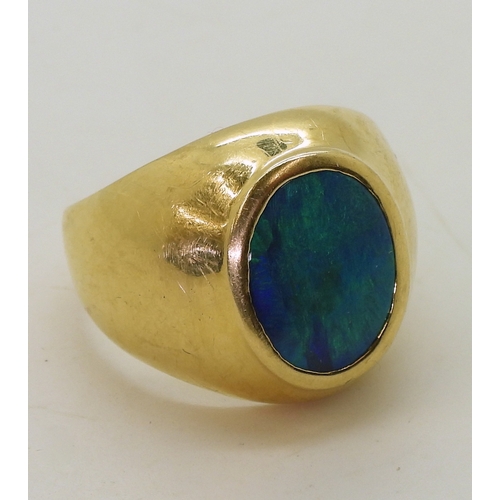 2721 - A GENTS OPAL SET RINGthe wide dome shaped ring is made of 18ct yellow gold , set with a 14mm x 10mm ... 