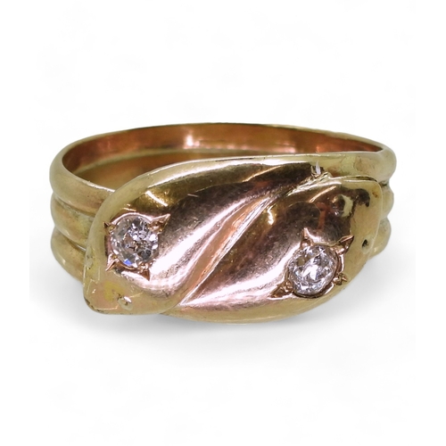 2726 - A 9CT GOLD SNAKE RINGthe double heads are set with 0.28cts of old cut diamonds combined. Chester hal... 