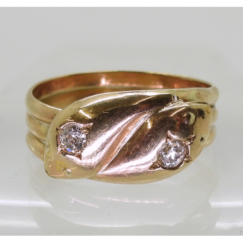 2726 - A 9CT GOLD SNAKE RINGthe double heads are set with 0.28cts of old cut diamonds combined. Chester hal... 