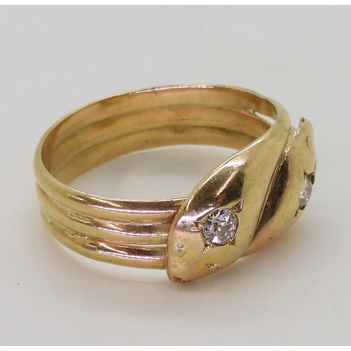 2726 - A 9CT GOLD SNAKE RINGthe double heads are set with 0.28cts of old cut diamonds combined. Chester hal... 