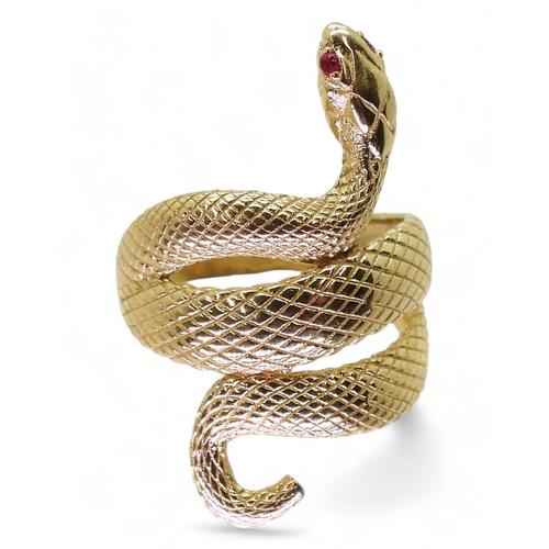 2729 - A 14K GOLD SNAKE RINGthe highly textured snake has ruby eyes, with lasered hallmark 585, finger size... 