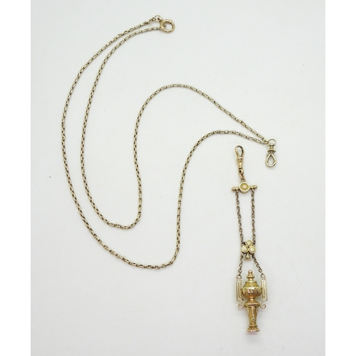 2733 - A VINTAGE GUARD CHAIN & PENDANT FOBthe pendant fob in three colour gold with urn design, faintly... 