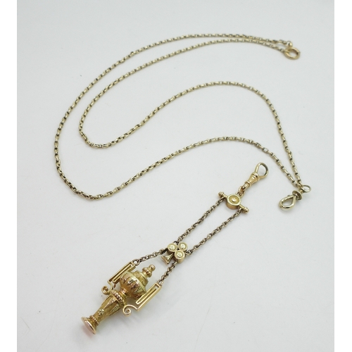 2733 - A VINTAGE GUARD CHAIN & PENDANT FOBthe pendant fob in three colour gold with urn design, faintly... 