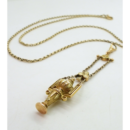 2733 - A VINTAGE GUARD CHAIN & PENDANT FOBthe pendant fob in three colour gold with urn design, faintly... 