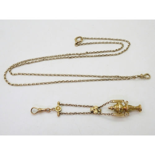 2733 - A VINTAGE GUARD CHAIN & PENDANT FOBthe pendant fob in three colour gold with urn design, faintly... 