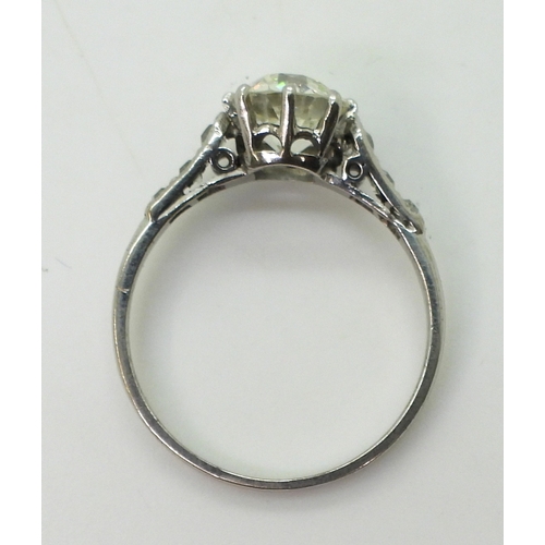 2744 - A VINTAGE DIAMOND SOLITAIRE RINGthe white metal mount is set with an old cut diamond of estimated ap... 