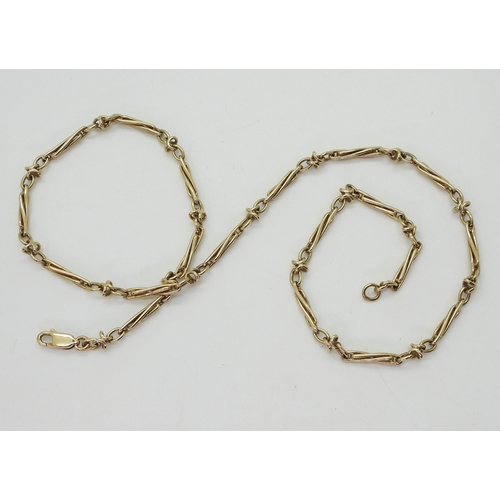 2745 - A 9CT GOLD FANCY CHAINwith twisted baton links. Length 52cm, weight 18.3gms