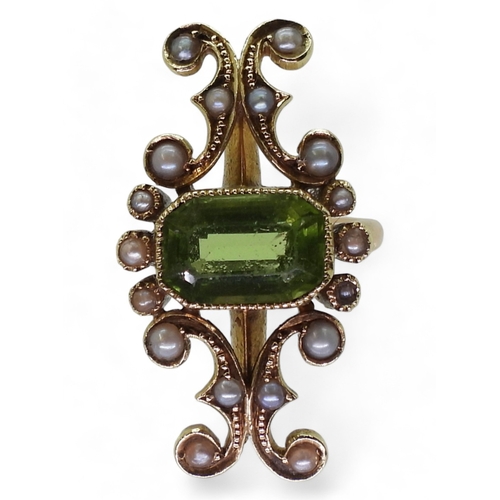 2748 - A VINTAGE PERIDOT & PEARL RINGwith an unusual linear scrolled design, the bright yellow metal he... 