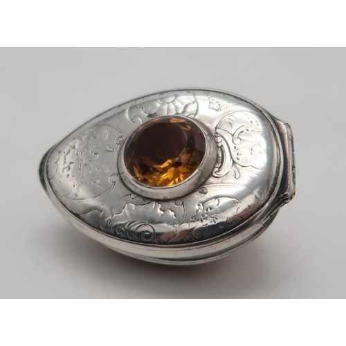 2500 - AN UNUSUAL SCOTTISH SILVER-MOUNTED COWRIE SHELL SNUFF BOXunmarked, inset with an amber cairngorm to ... 