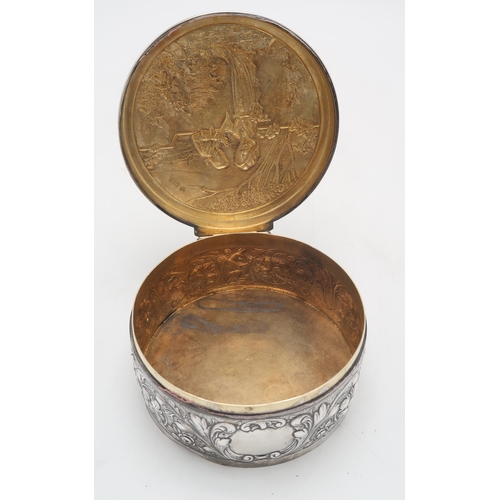 2519 - AN EDWARDIAN SILVER CIRCULAR BOXby Blackburn & Tysall, London 1903, the lid with repousse decora... 