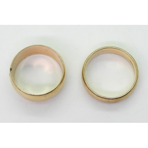 9002 - Two 9ct gold wedding rings, wide, size V1/2, shallow court W1/2, weight together 15gms (2)