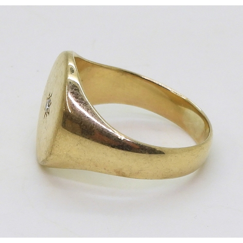 9008 - A diamond set oval faced signet ring, size X, weight 9.8gms (1)