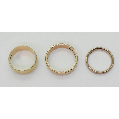 9021 - Three 9ct gold wedding rings, sizes W (with a tiny star set diamond), size Q1/2, size N, weight toge... 