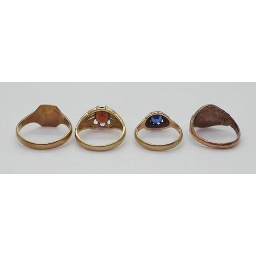 9022 - Four 9ct gold rings. Two signet rings, square faced, size W1/2, oval (hollow af) size R, a garnet se... 