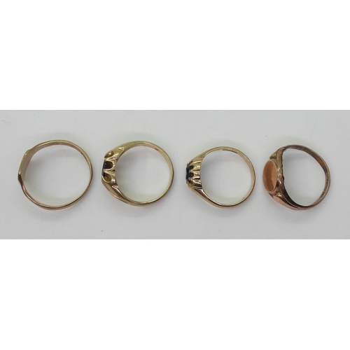 9022 - Four 9ct gold rings. Two signet rings, square faced, size W1/2, oval (hollow af) size R, a garnet se... 