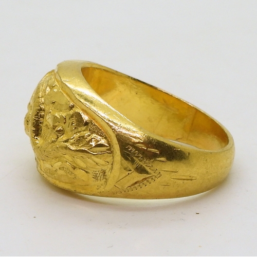 9030 - A Chinese dragon ring, in bright yellow metal with Chinese character stamps and 96.5%, finger size Y... 