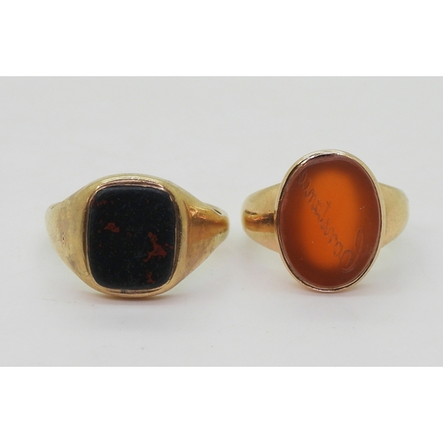 9041 - Two yellow metal signet rings, a bloodstone example size V, together with a carnelian example intagl... 