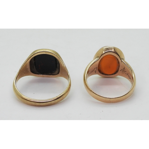 9041 - Two yellow metal signet rings, a bloodstone example size V, together with a carnelian example intagl... 