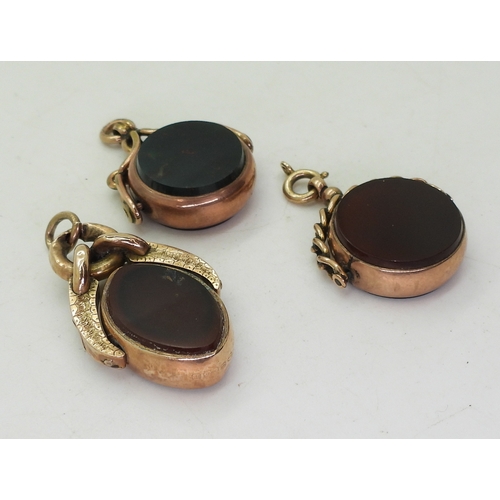 9122 - Three 9ct gold mounted fob seals set with bloodstone and carnelian, weight together 21.6gms