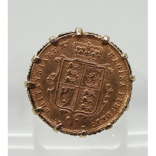 9128 - An 1863 Shield back gold half sovereign, in a decorative 9ct ring mount, size R1/2, weight 8.2gms