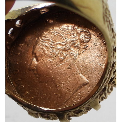 9128 - An 1863 Shield back gold half sovereign, in a decorative 9ct ring mount, size R1/2, weight 8.2gms