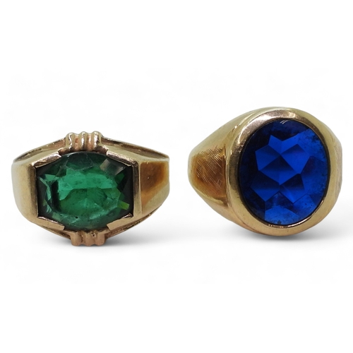 9129 - Two 10k gold rings set with glass gems, blue size T1/2, green size Q, weight combined 15.6gms