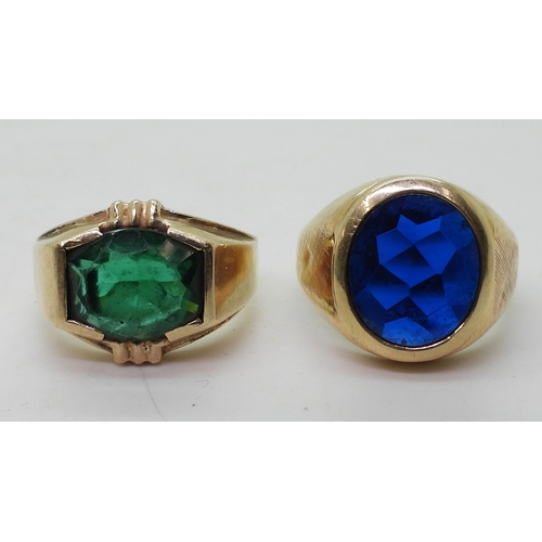 9129 - Two 10k gold rings set with glass gems, blue size T1/2, green size Q, weight combined 15.6gms