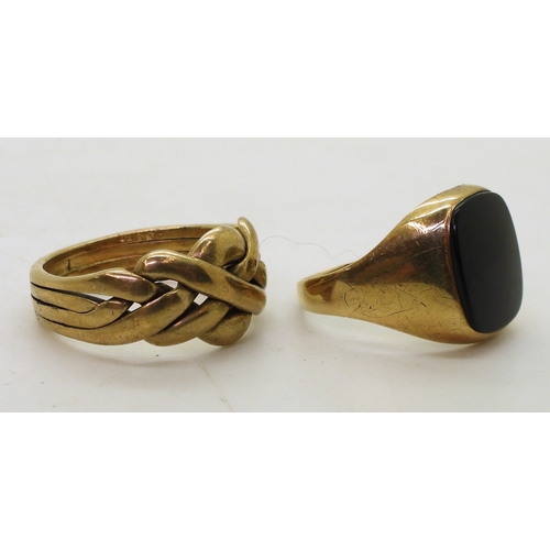 9131 - A 9ct gold puzzle ring, (soldered shut) size V, and a 9ct onyx signet ring, size R, weight together ... 