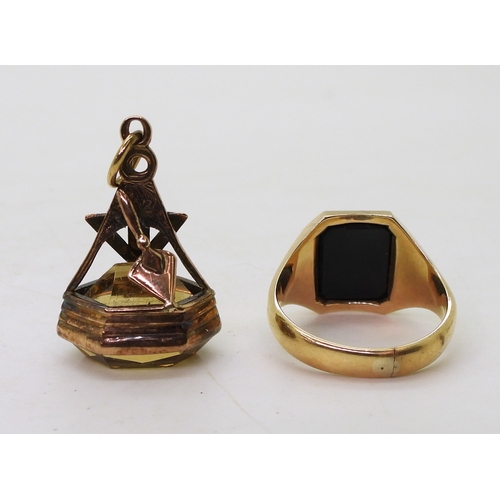 9140 - A 9ct gold carved onyx Masonic ring, size T1/2, together with a vintage Masonic citrine fob seal mad... 