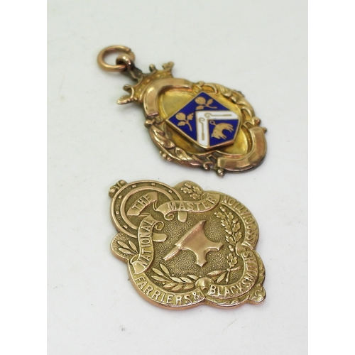 9143 - A 9ct gold the National Master Farriers & Blacksmiths Association medallion, (bail missing) toge... 