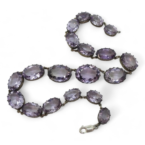 2771 - AN AMETHYST RIVIERA NECKLACEthe amethysts taper in size from 21.7mm x 16.5mm to 12.9mm x 9.7mm and a... 