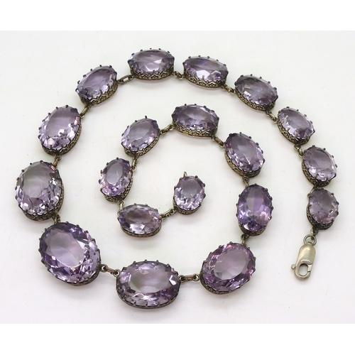 2771 - AN AMETHYST RIVIERA NECKLACEthe amethysts taper in size from 21.7mm x 16.5mm to 12.9mm x 9.7mm and a... 