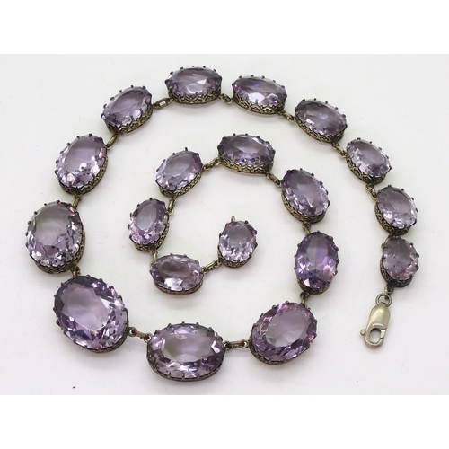 2771 - AN AMETHYST RIVIERA NECKLACEthe amethysts taper in size from 21.7mm x 16.5mm to 12.9mm x 9.7mm and a... 