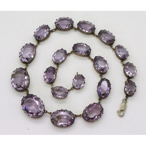 2771 - AN AMETHYST RIVIERA NECKLACEthe amethysts taper in size from 21.7mm x 16.5mm to 12.9mm x 9.7mm and a... 