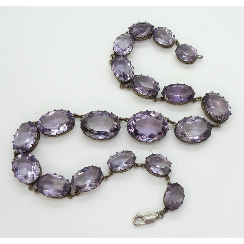 2771 - AN AMETHYST RIVIERA NECKLACEthe amethysts taper in size from 21.7mm x 16.5mm to 12.9mm x 9.7mm and a... 