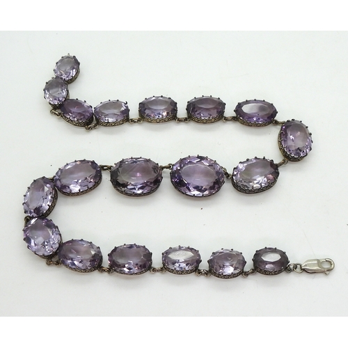 2771 - AN AMETHYST RIVIERA NECKLACEthe amethysts taper in size from 21.7mm x 16.5mm to 12.9mm x 9.7mm and a... 