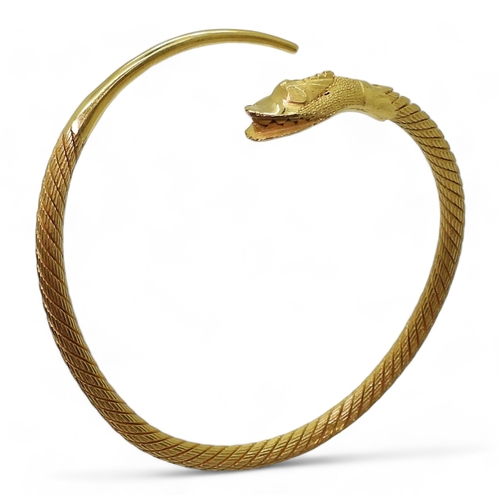 2772 - AN ARABIC GOLD SNAKE BANGLEthe twisted wire body has a springy feel to it, with solid tail and head,... 