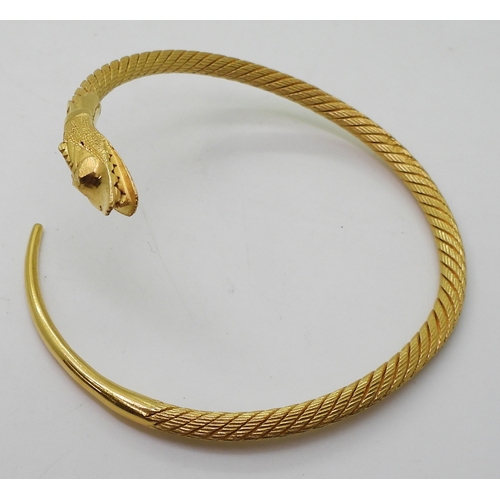 2772 - AN ARABIC GOLD SNAKE BANGLEthe twisted wire body has a springy feel to it, with solid tail and head,... 