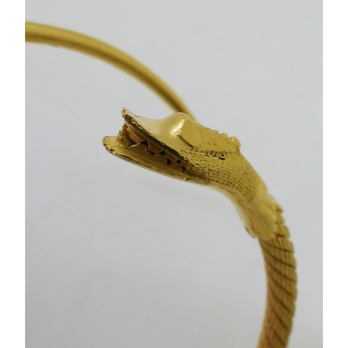 2772 - AN ARABIC GOLD SNAKE BANGLEthe twisted wire body has a springy feel to it, with solid tail and head,... 