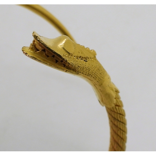 2772 - AN ARABIC GOLD SNAKE BANGLEthe twisted wire body has a springy feel to it, with solid tail and head,... 