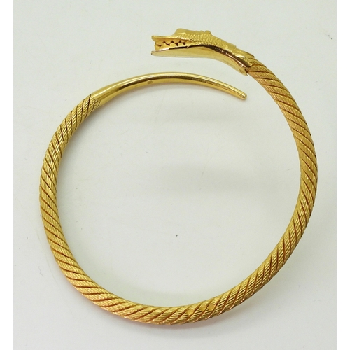 2772 - AN ARABIC GOLD SNAKE BANGLEthe twisted wire body has a springy feel to it, with solid tail and head,... 