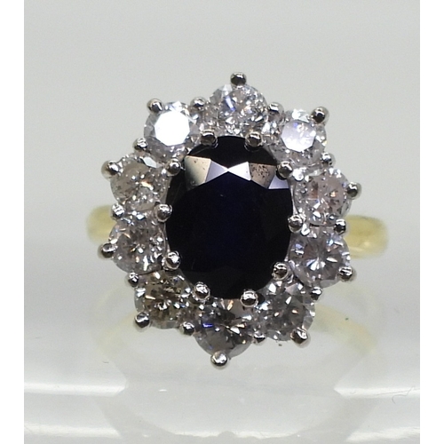 2765 - A SUBSTANTIAL CLUSTER RING,set with a 9.5mm x 7.5mm x 4.7mm oval cut sapphire, surrounded with estim... 