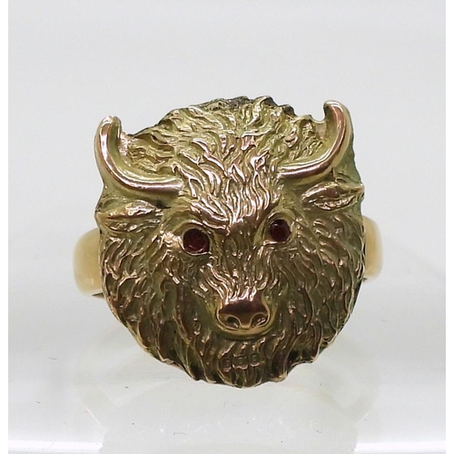 767 - A 9ct gold buffalo head ring with red gem eyes, size approx Q, weight 7.8gms