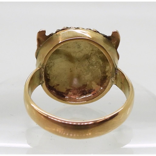 767 - A 9ct gold buffalo head ring with red gem eyes, size approx Q, weight 7.8gms